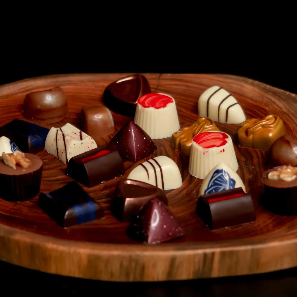 Original CMV chocolate assortment on a wooden platter
